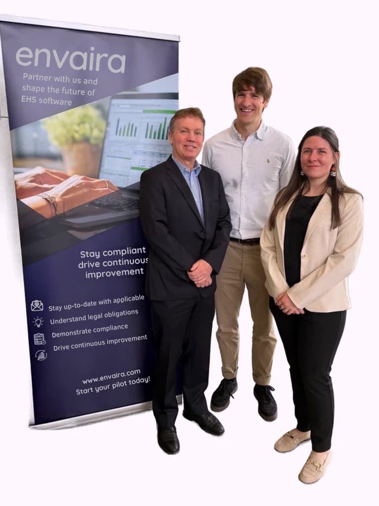 Envaira co-founders Michael O’Shea, Eugene Cush and Katie Vellner standing beside an Envaira banner